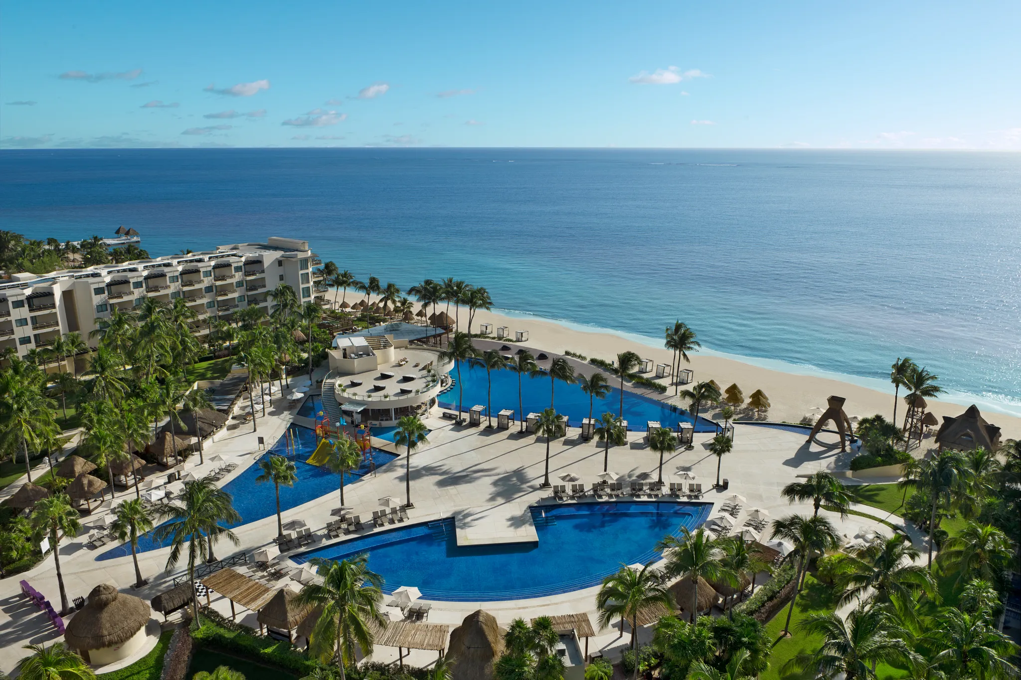 Aerial view of pools and beachfront at Dreams Riviera Cancun Resort & Spa in Riviera Maya.