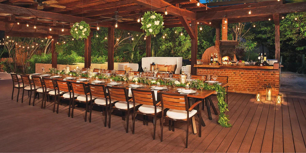 Chef’s Garden outdoor reception setup with long dining table and string lights at Dreams Riviera Cancun