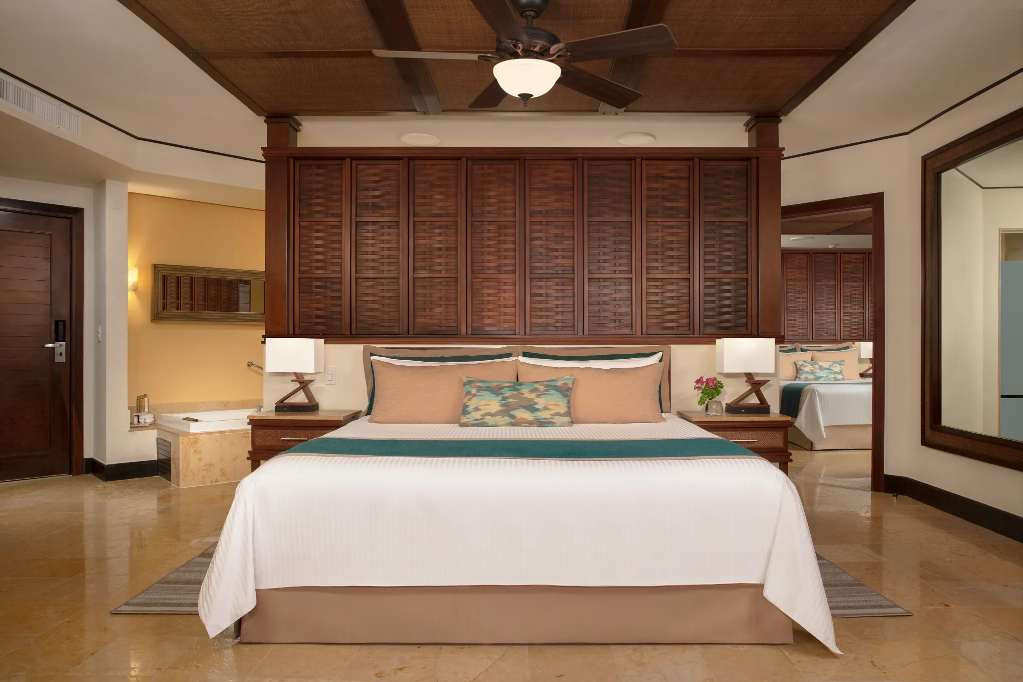 Family Suite Premium king bedroom with tropical décor at Dreams Riviera Cancun Resort & Spa.