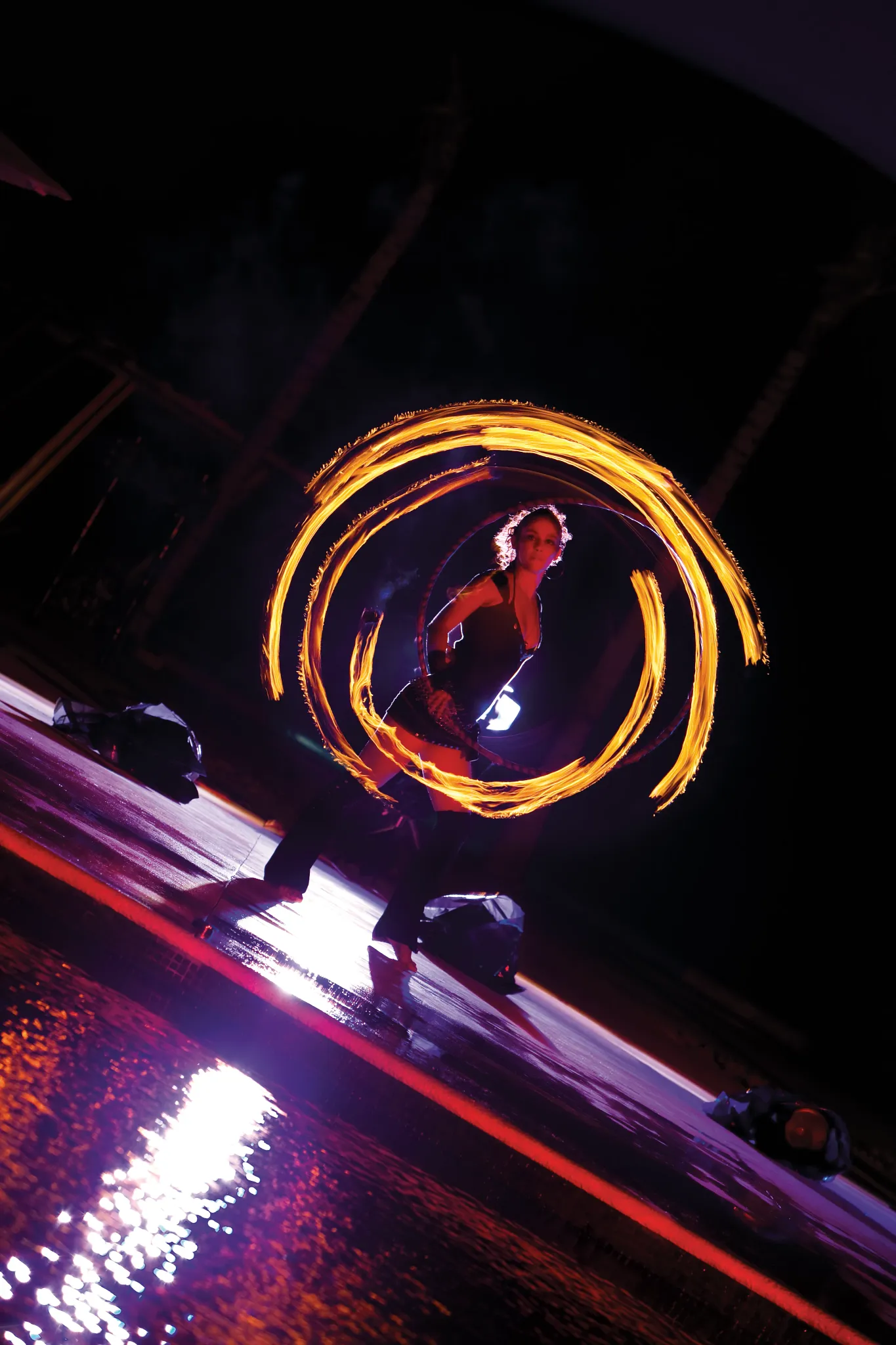 Fire dancer performing at night show near the pool at Dreams Riviera Cancun Resort & Spa.