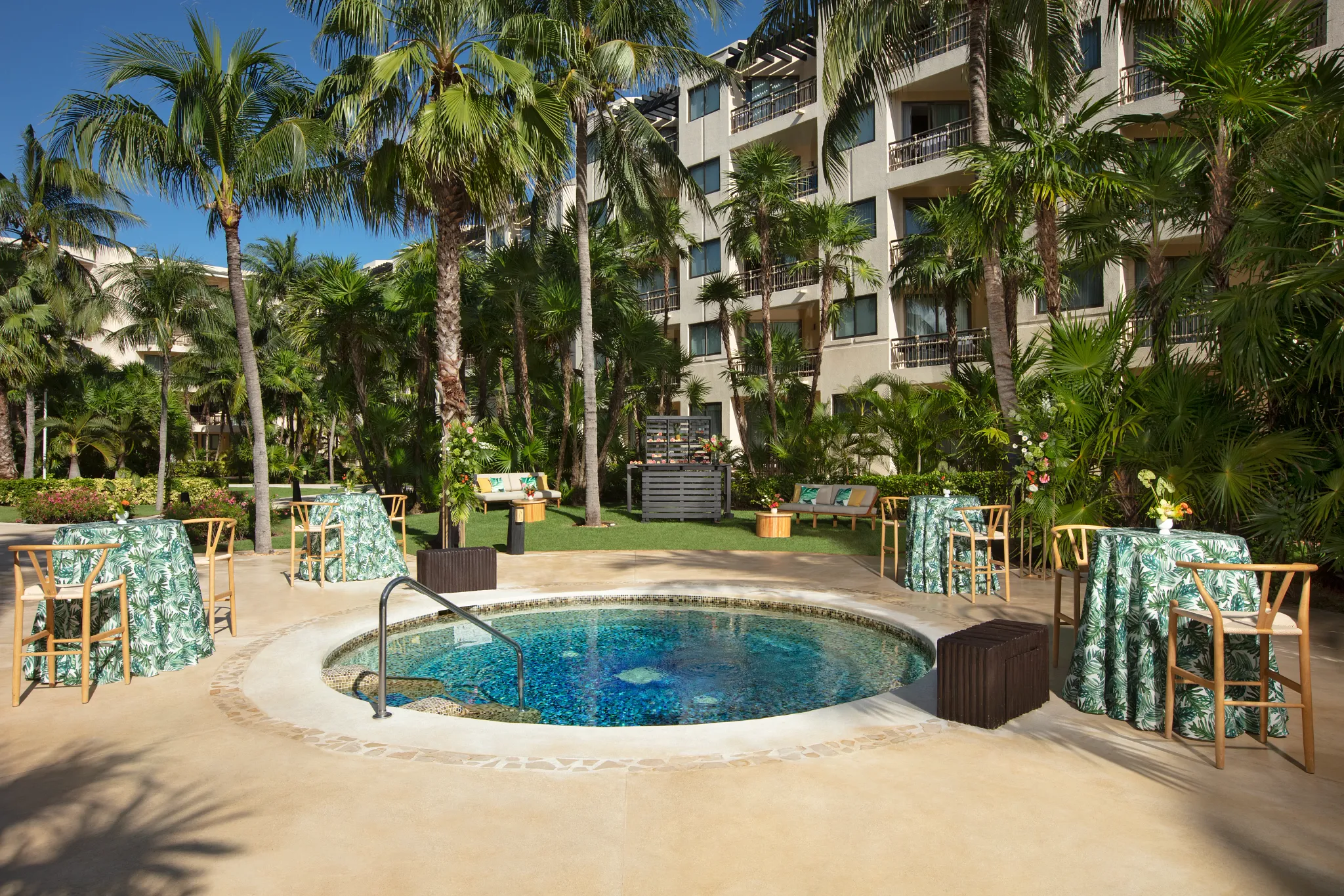 Poolside jacuzzi cocktail reception setup with tropical décor at Dreams Riviera Cancun