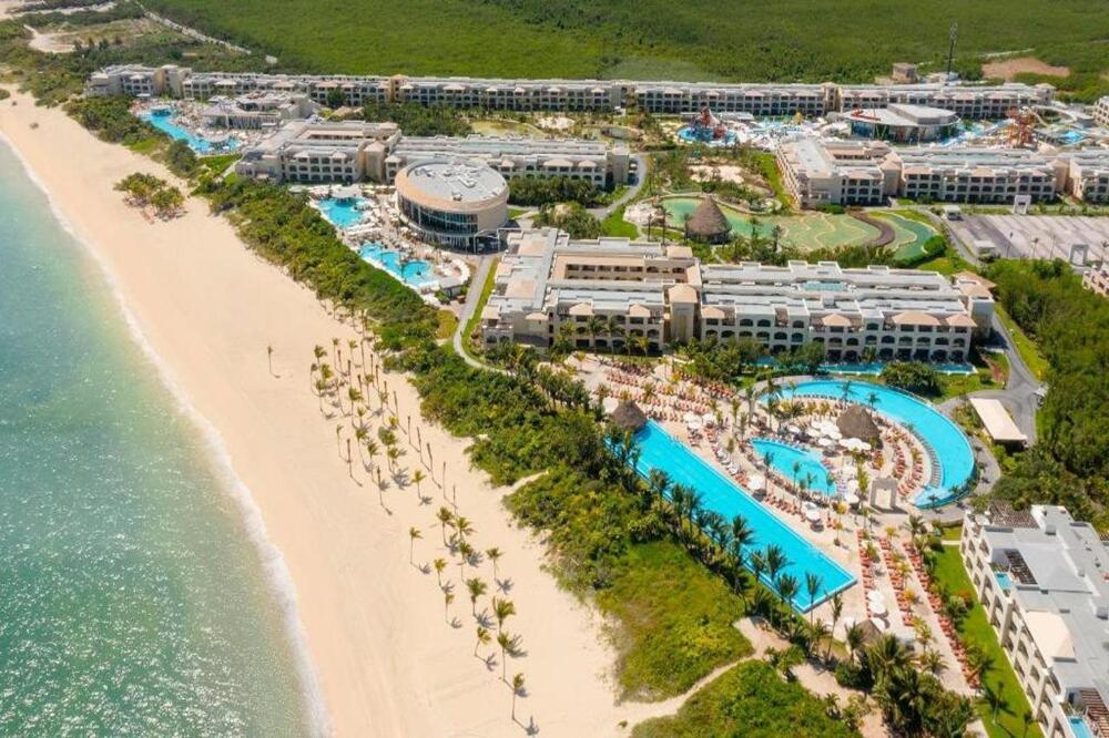 Moon Palace The Grand Cancun mega-resort aerial view with expansive pools, waterpark, golf course, and beachfront in Cancun's Hotel Zone.