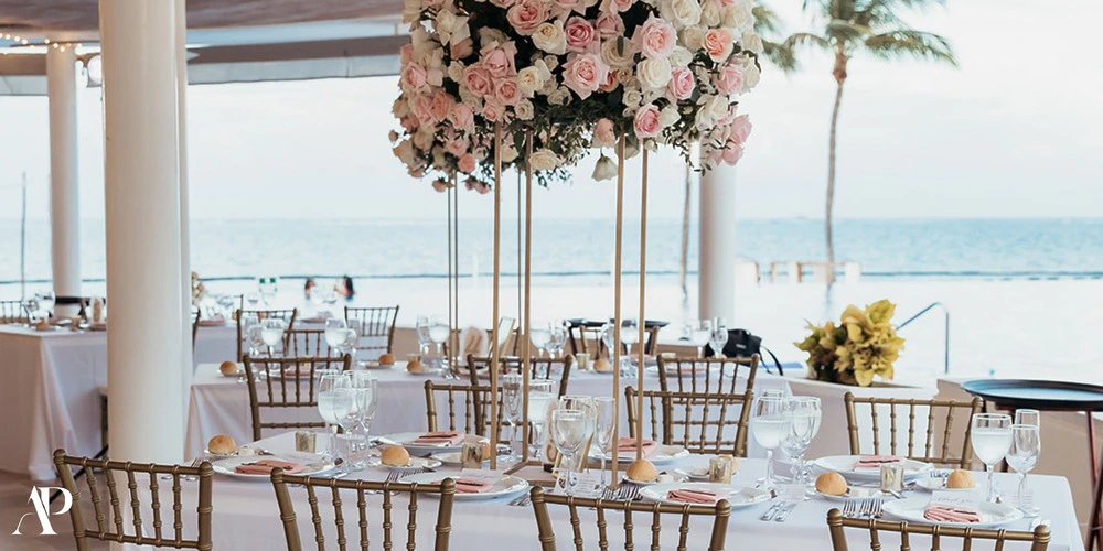 Oceana Restaurant wedding reception setup with floral centerpieces and ocean views at Dreams Riviera Cancun
