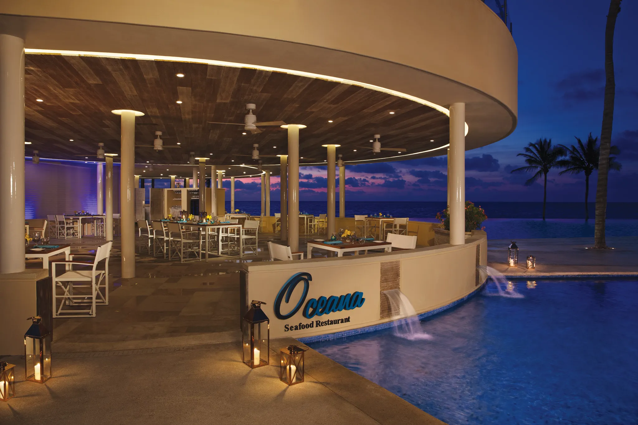 Oceana seafood restaurant at Dreams Riviera Cancun Resort & Spa featuring open-air dining, ocean views, and fresh grilled seafood dishes.