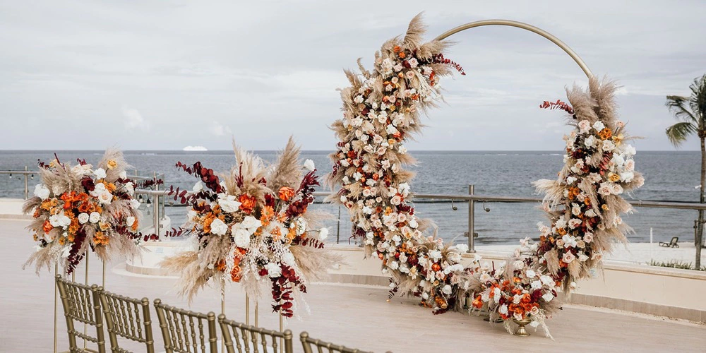 Oceanfront circular floral arch wedding setup at Oceana Sky Terrace at Dreams Riviera Cancun