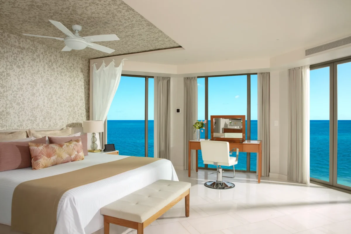 Preferred Club Ocean Front Bridal Suite bedroom with king bed and panoramic ocean view at Dreams Riviera Cancun Resort & Spa.