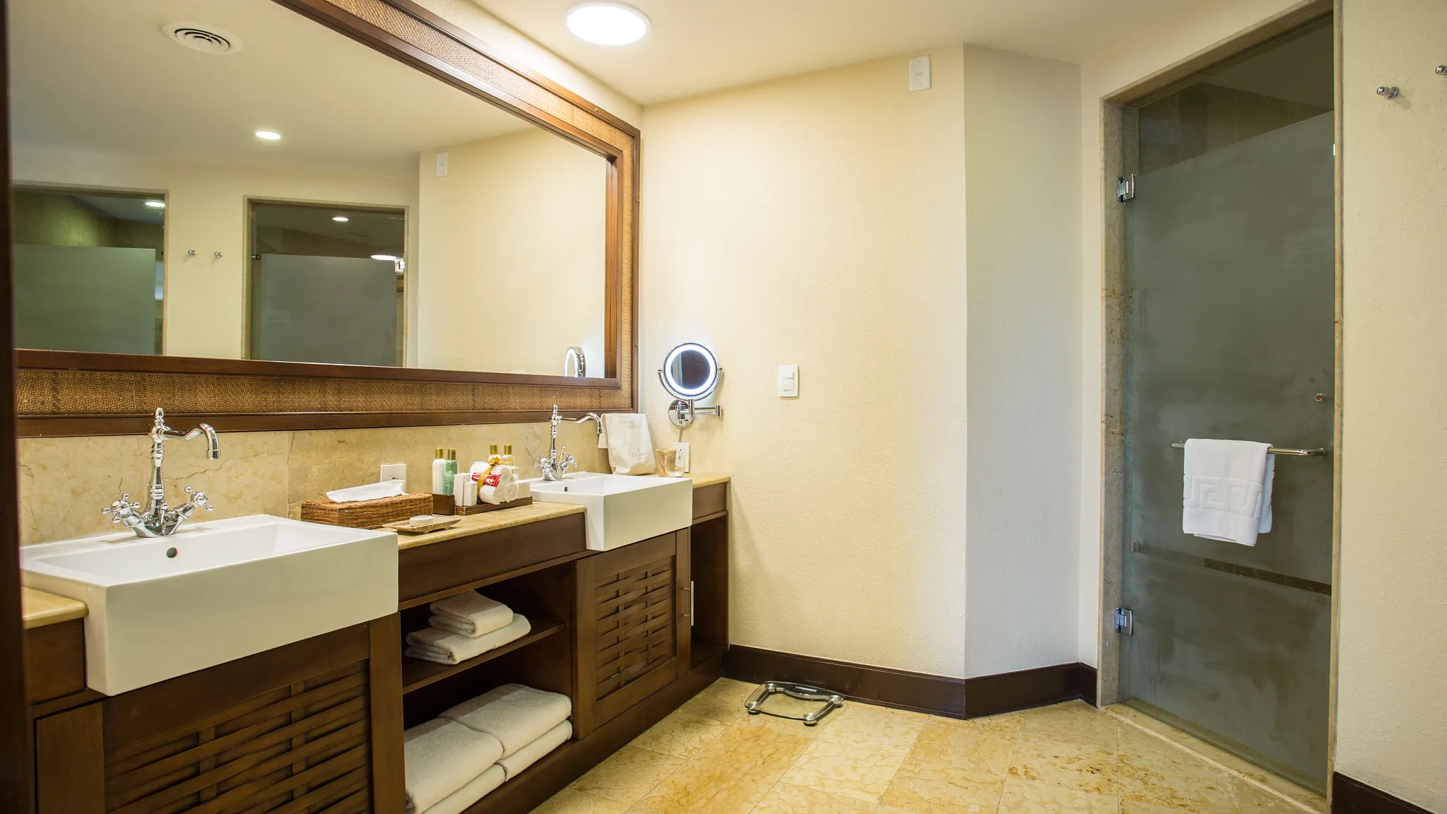 Preferred Club Ocean Front Governor Suite bathroom with double sinks and walk-in shower at Dreams Riviera Cancun Resort & Spa.