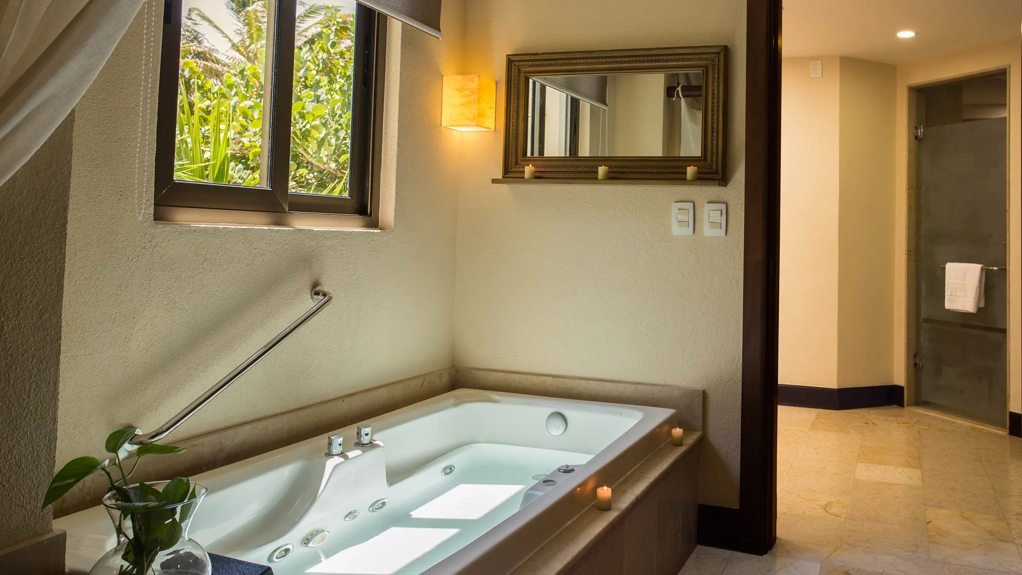 Preferred Club Ocean Front Governor Suite bathroom with indoor hot tub and elegant lighting at Dreams Riviera Cancun Resort & Spa.