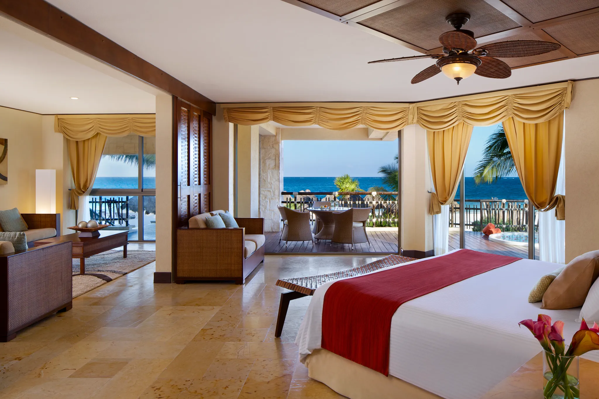 Preferred Club Ocean Front Governor Suite open layout with bedroom and ocean view at Dreams Riviera Cancun Resort & Spa.