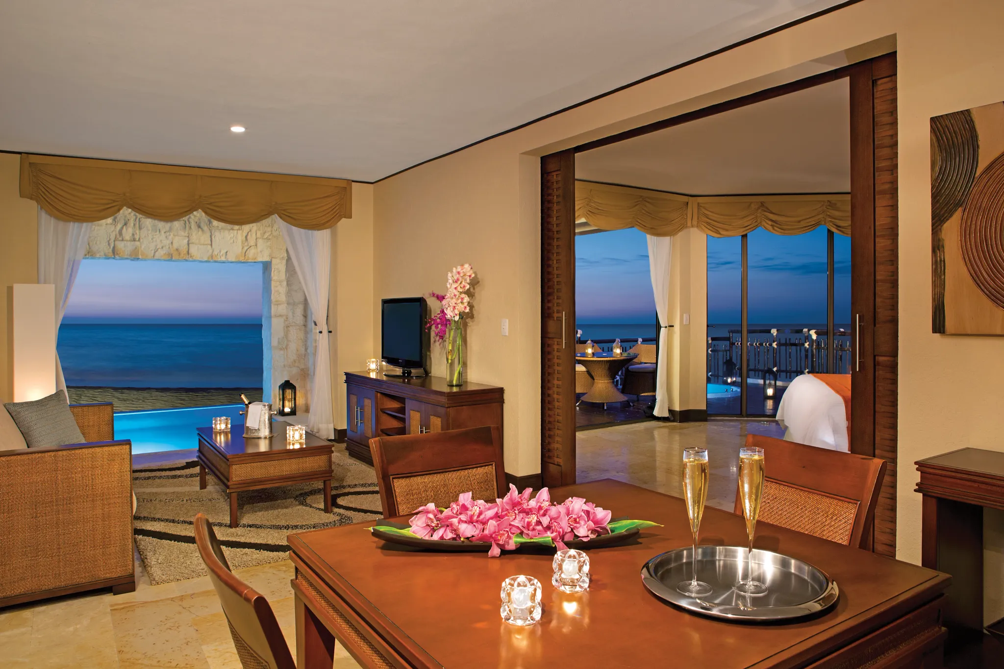Preferred Club Ocean Front Governor Suite living area with sofa and oceanfront terrace access at Dreams Riviera Cancun Resort & Spa.