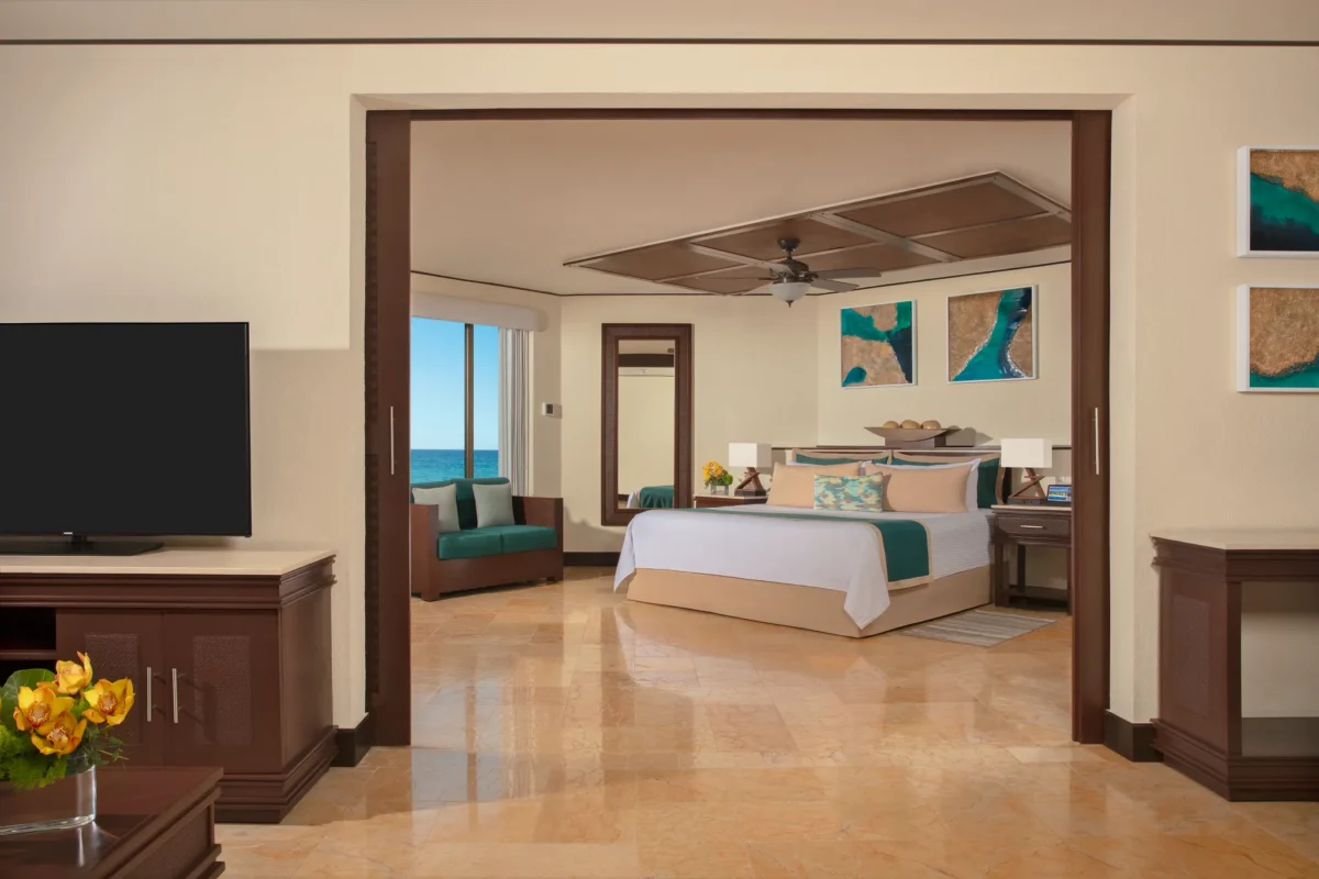 Preferred Club Ocean Front Master Suite bedroom with king bed and ocean view at Dreams Riviera Cancun Resort & Spa.