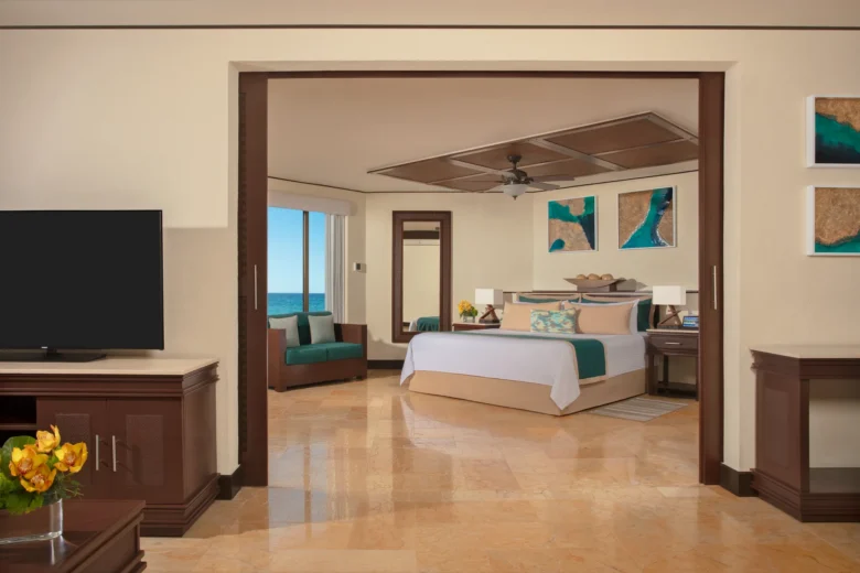 Preferred Club Ocean Front Master Suite bedroom with king bed and ocean view at Dreams Riviera Cancun Resort & Spa.