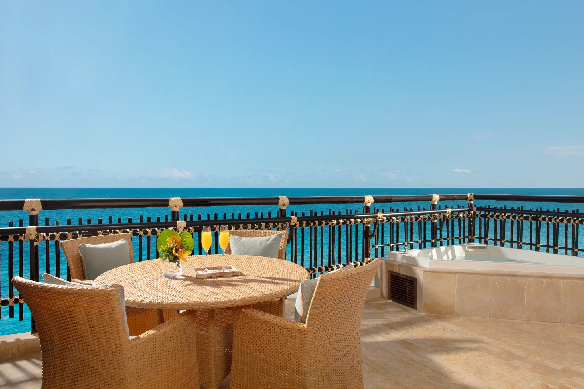 Preferred Club Ocean Front Master Suite terrace with outdoor dining and hot tub overlooking the ocean at Dreams Riviera Cancun Resort & Spa.
