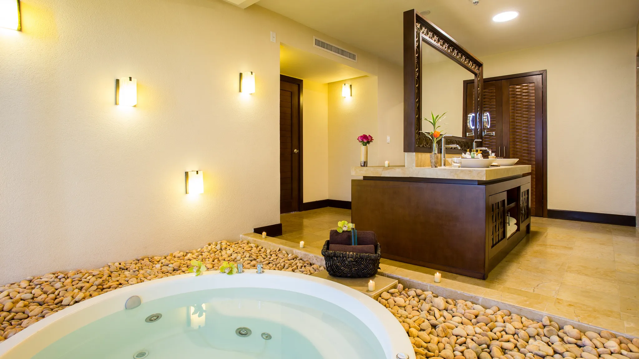 Preferred Club Ocean Front Presidential Suite bathroom with indoor hot tub and double vanity at Dreams Riviera Cancun Resort & Spa.