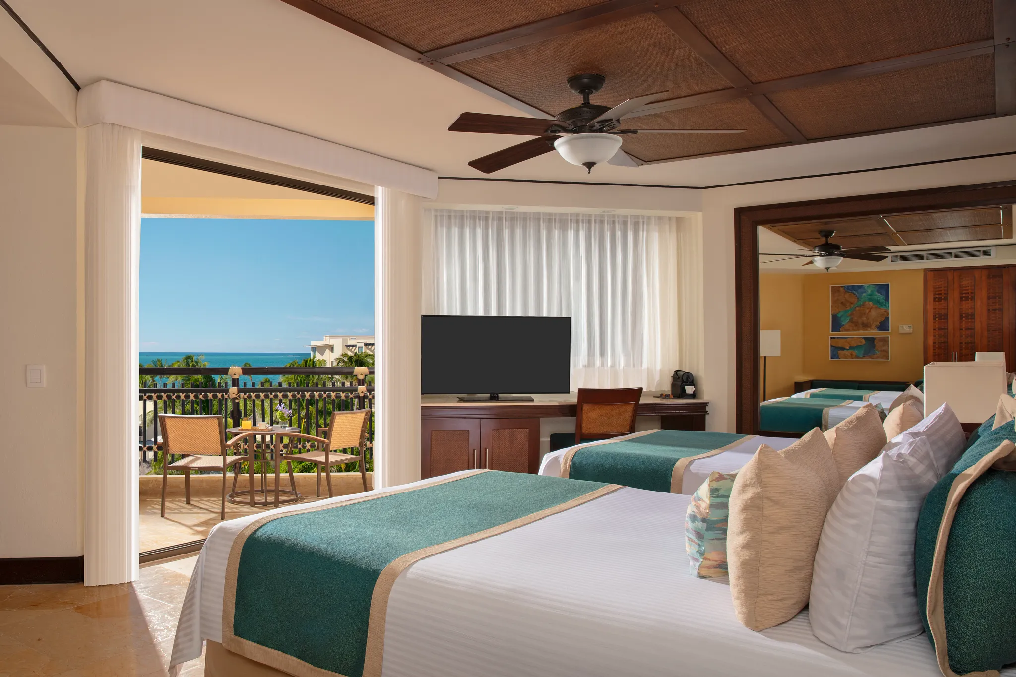 Preferred Club Ocean View room with two double beds and balcony overlooking the ocean at Dreams Riviera Cancun.