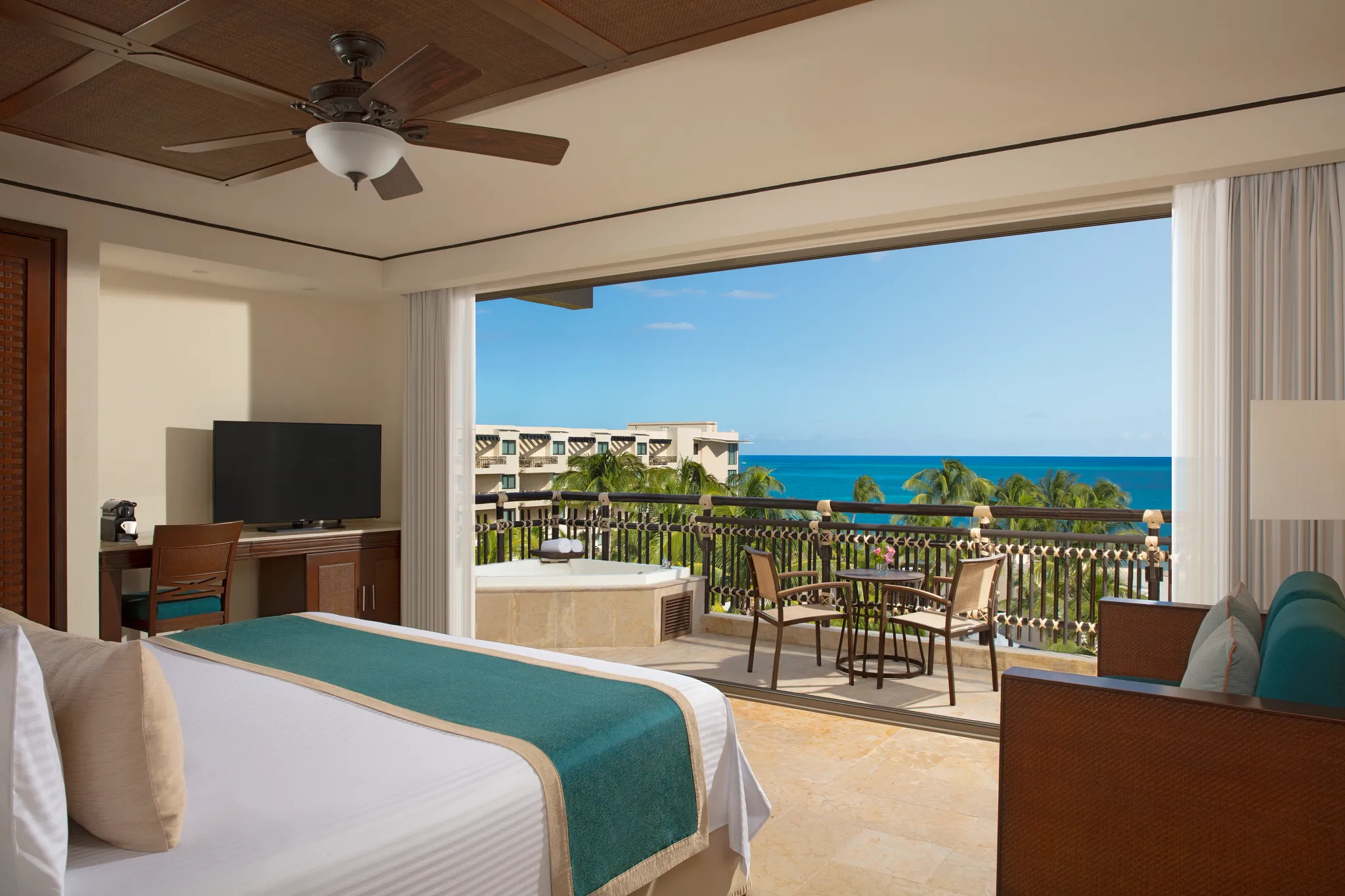 Preferred Club Ocean View & Pool Front king room with balcony and ocean views at Dreams Riviera Cancun.
