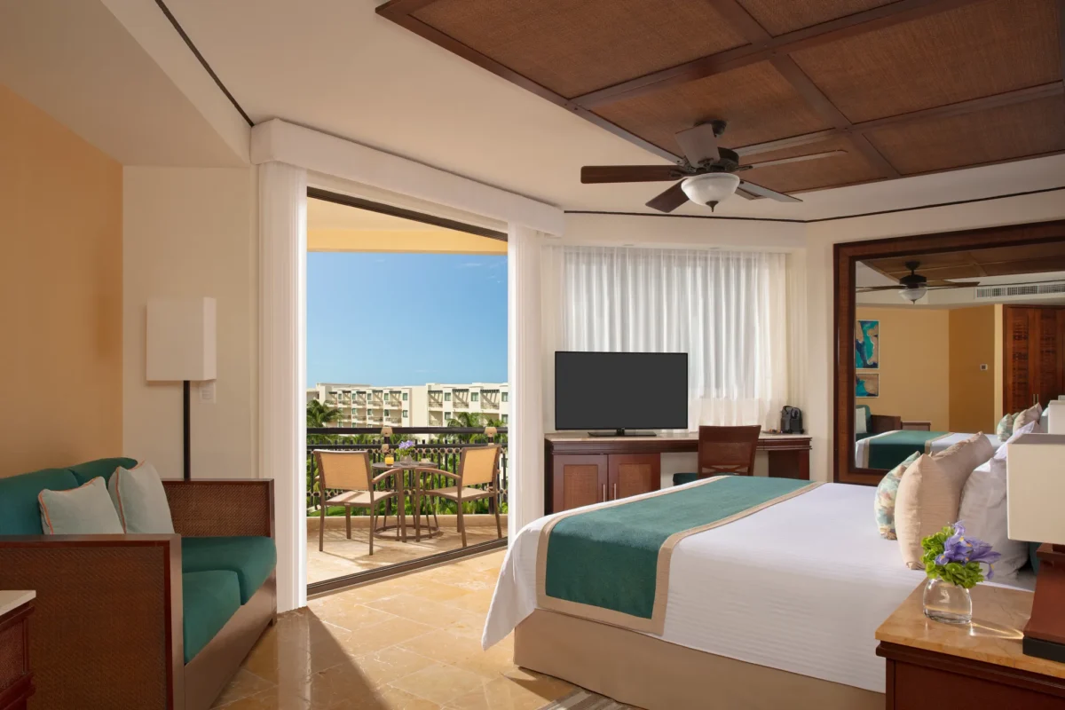 Preferred Club Tropical View room with king bed and balcony access at Dreams Riviera Cancun Resort.
