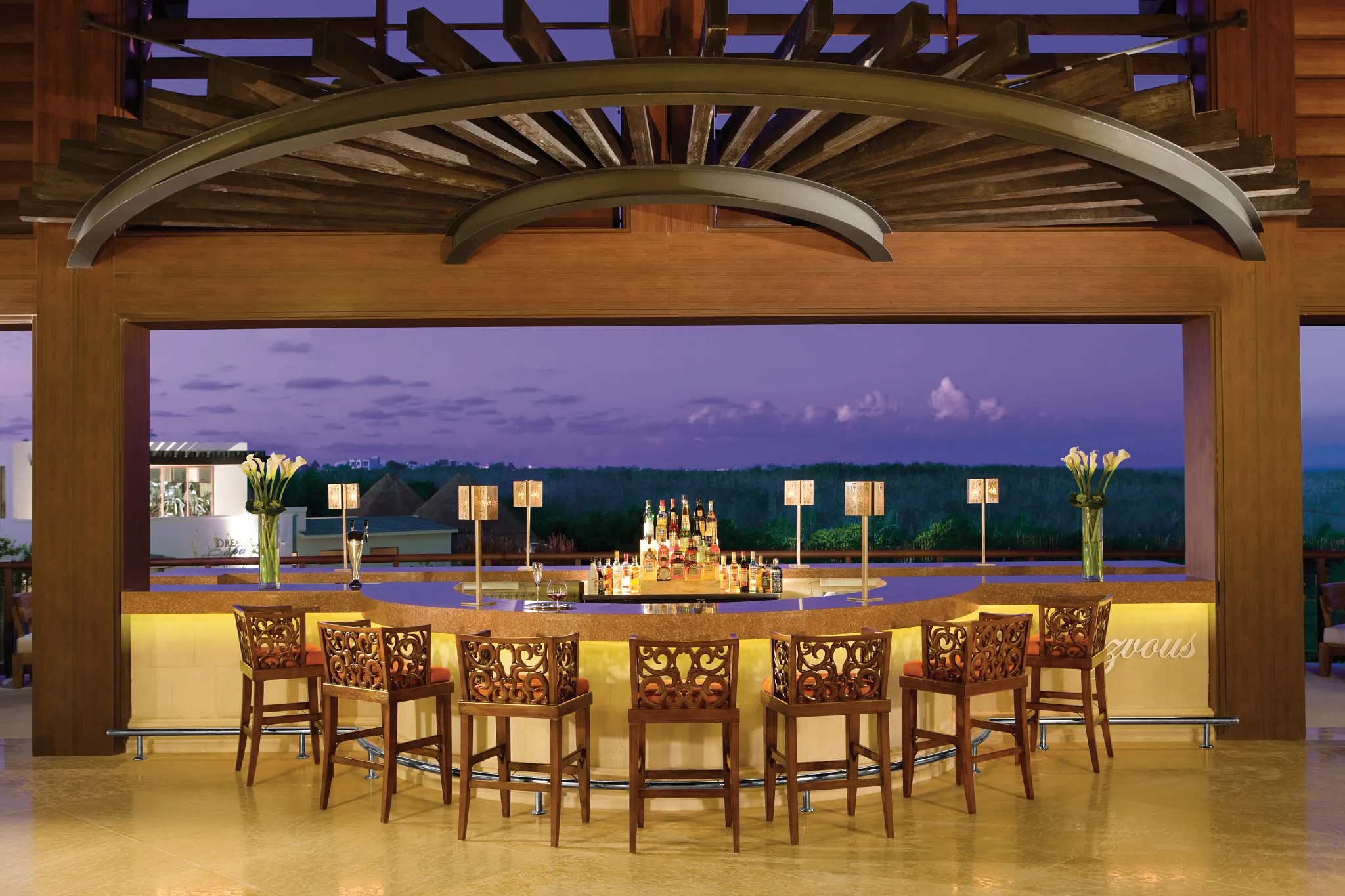 Rendezvous Lobby Bar at Dreams Riviera Cancun Resort & Spa featuring elegant lounge seating, cocktails, and live music in the main lobby.