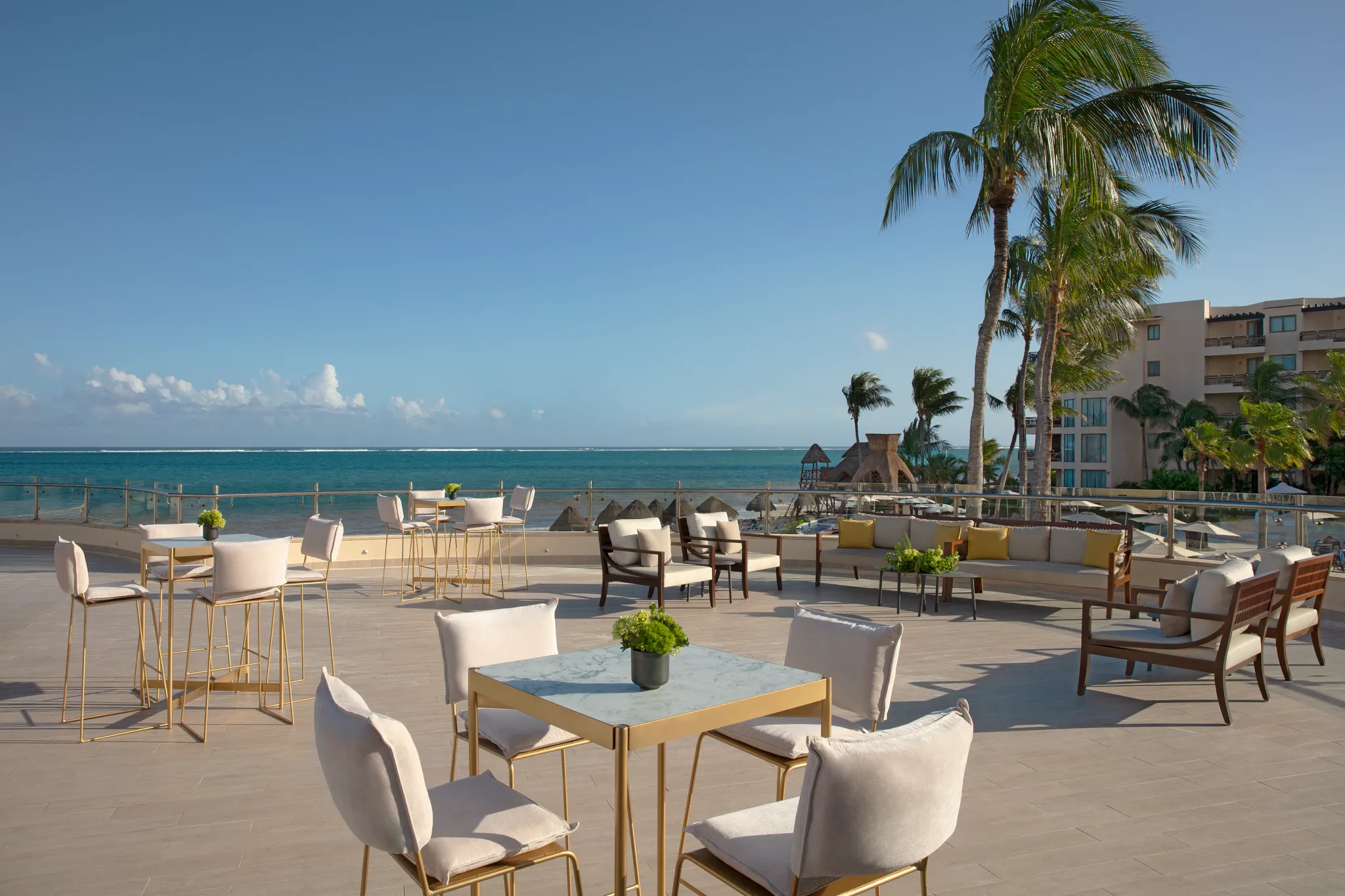 Rooftop terrace with ocean views and lounge seating at Dreams Riviera Cancun Resort & Spa.