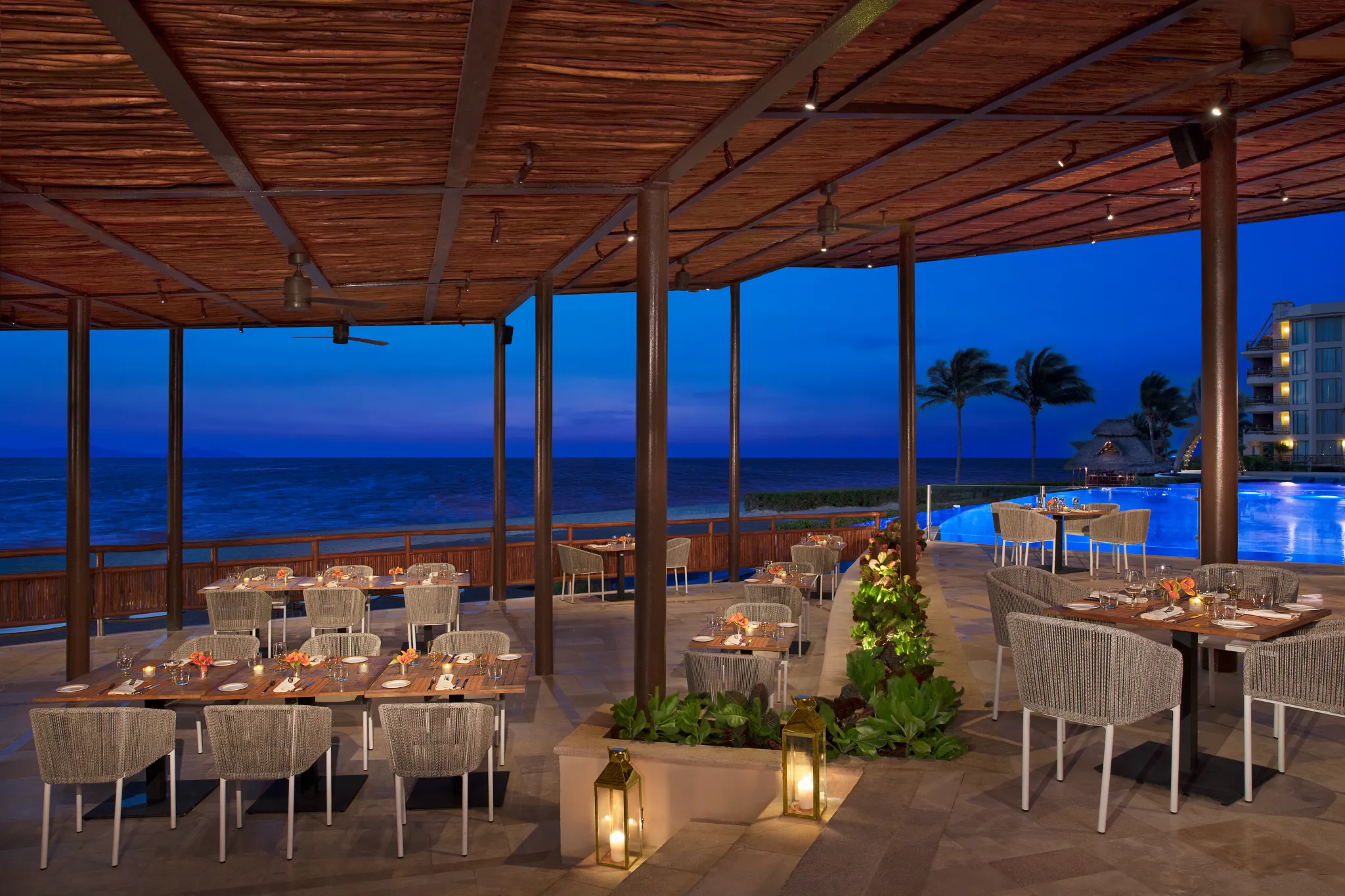 Seaside Grill at Dreams Riviera Cancun Resort & Spa featuring open-air dining, ocean views, and grilled steaks, seafood, and poultry.