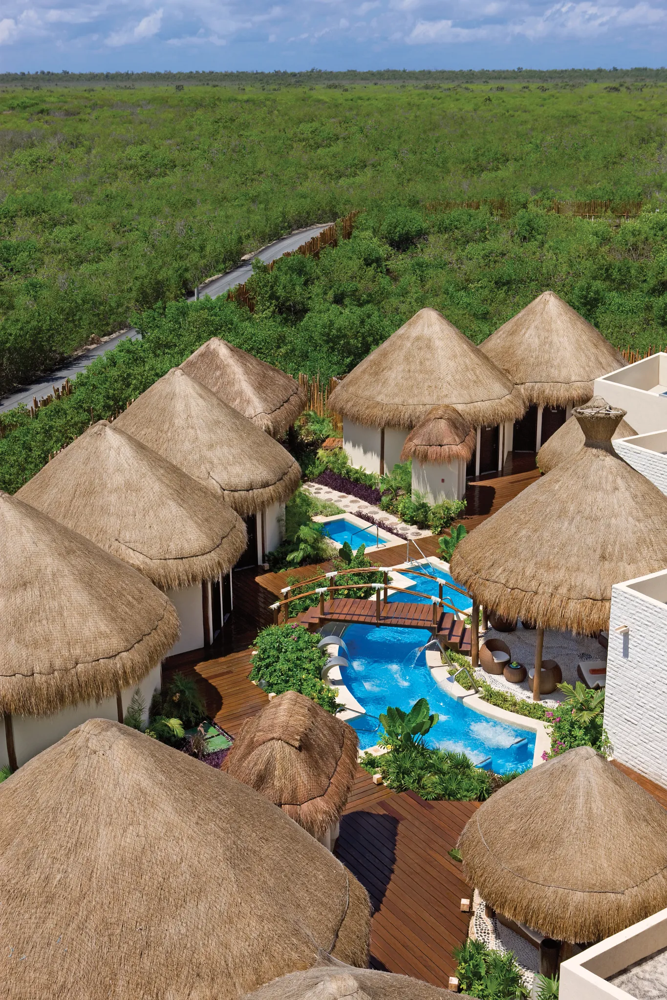 Aerial view of spa palapas and hydrotherapy pools at Dreams Riviera Cancun Resort & Spa.
