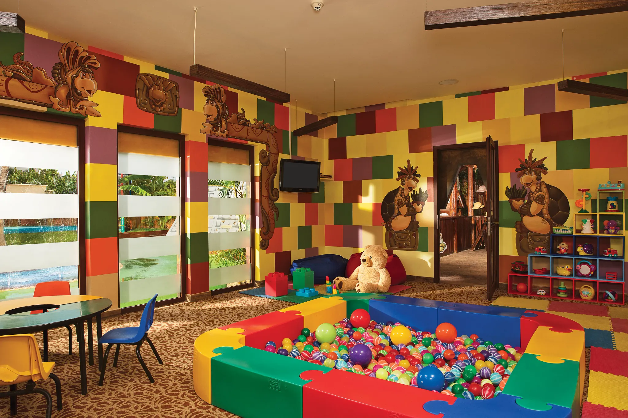 Colorful toddler playroom with ball pit and toys at Dreams Riviera Cancun Resort & Spa kids club.