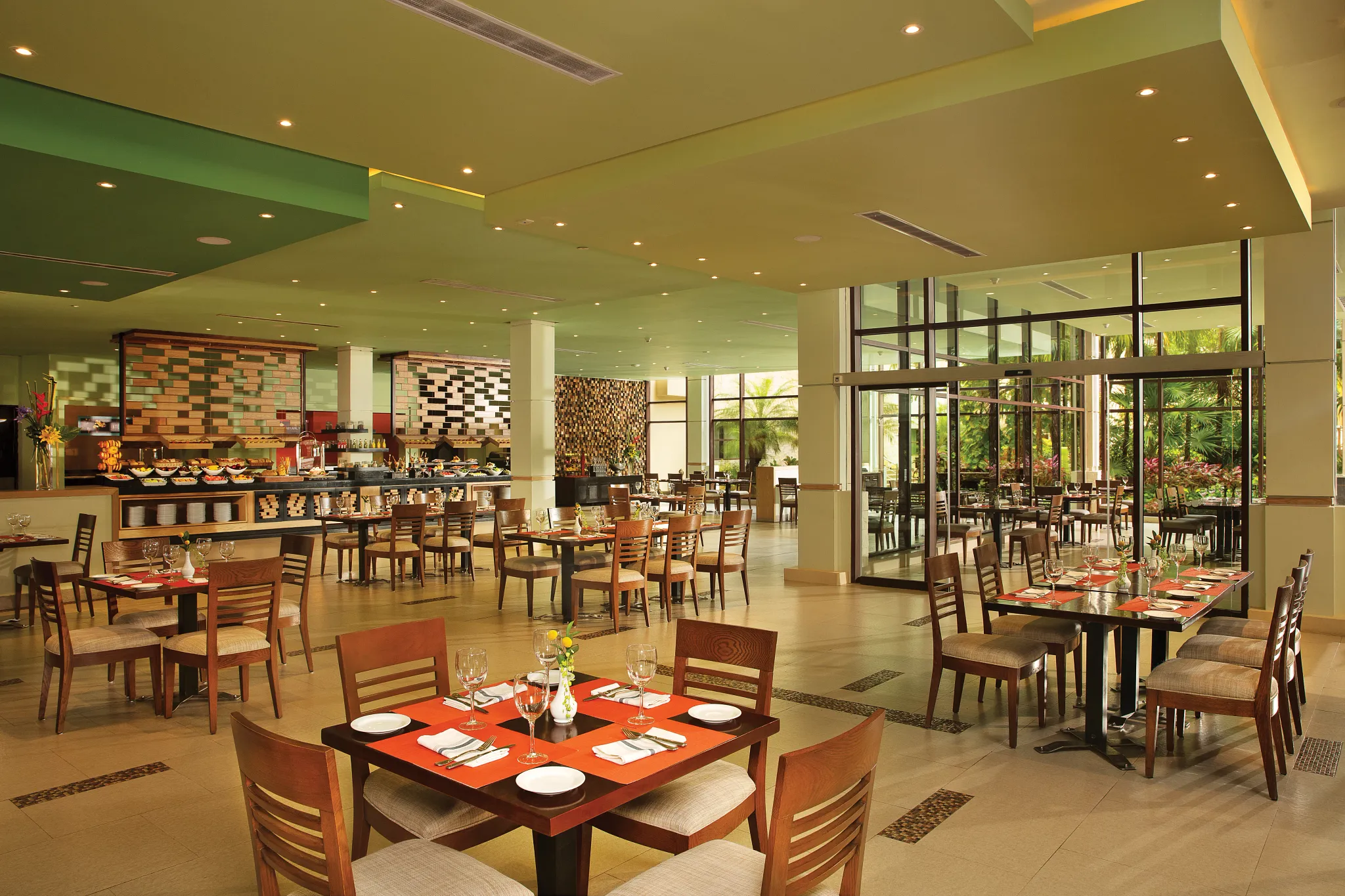 World Café buffet restaurant at Dreams Riviera Cancun Resort & Spa featuring international cuisine stations, spacious dining area, and casual family-friendly atmosphere.